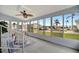 Enclosed porch with ceiling fan, seating area, and views of the community at 122 E Saint Johns Way, Apollo Beach, FL 33572