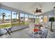 Enclosed porch with ceiling fan, seating area, and views of the community at 122 E Saint Johns Way, Apollo Beach, FL 33572