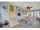Enclosed porch with ceiling fan, seating area, and views of the community at 122 E Saint Johns Way, Apollo Beach, FL 33572