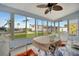 Enclosed porch with ceiling fan, seating area, and views of the community at 122 E Saint Johns Way, Apollo Beach, FL 33572