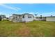 Single-story home with covered porch and green lawn at 122 E Saint Johns Way, Apollo Beach, FL 33572