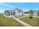 Cute light blue home with walkway and landscaping at 122 E Saint Johns Way, Apollo Beach, FL 33572