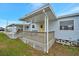 Light blue home with covered porch and access ramp at 122 E Saint Johns Way, Apollo Beach, FL 33572