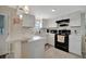 Updated kitchen with white cabinets and black appliances at 122 E Saint Johns Way, Apollo Beach, FL 33572
