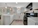White kitchen with stainless steel appliances and breakfast bar at 122 E Saint Johns Way, Apollo Beach, FL 33572