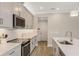 Modern kitchen with stainless steel appliances and breakfast bar at 4351 Cloud Hopper Way, Lutz, FL 33559
