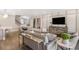 Open living room with modern furniture and large TV at 4351 Cloud Hopper Way, Lutz, FL 33559