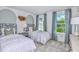 Charming bedroom with twin beds, ample natural light, and a view of the backyard at 4351 Cloud Hopper Way, Lutz, FL 33559