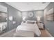 Cozy bedroom with a comfortable bed and large mirror at 4351 Cloud Hopper Way, Lutz, FL 33559