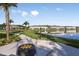 Community fire pit area with a lake view and walking path at 4351 Cloud Hopper Way, Lutz, FL 33559