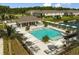 Community pool with plenty of lounge chairs and umbrellas at 4351 Cloud Hopper Way, Lutz, FL 33559
