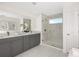 Elegant bathroom with a double vanity, large shower, and marble flooring at 4351 Cloud Hopper Way, Lutz, FL 33559
