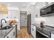 Modern kitchen features stainless steel appliances and a gray quartz island at 4357 Cloud Hopper Way, Lutz, FL 33559