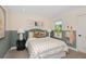 Charming bedroom with a teal headboard and patterned bedding at 4357 Cloud Hopper Way, Lutz, FL 33559