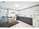 Modern kitchen with dark and white cabinets, white countertops, and stainless steel appliances at 7511 Tyson Dr, Port Richey, FL 34668