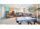 Relaxing sunroom with air hockey, seating area, and lots of windows at 7511 Tyson Dr, Port Richey, FL 34668
