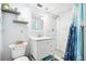 Clean bathroom with updated vanity, marble shower, and ocean-themed decor at 7511 Tyson Dr, Port Richey, FL 34668