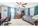 Spacious bedroom with a bed, gaming setup, and ample natural light at 7511 Tyson Dr, Port Richey, FL 34668