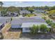 Aerial view of a single-story house with a large backyard and surrounding neighborhood at 7511 Tyson Dr, Port Richey, FL 34668