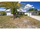Single story house with palm tree and carport at 7511 Tyson Dr, Port Richey, FL 34668