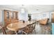 Spacious dining area with an oval table, wooden chairs, and a built-in hutch at 7511 Tyson Dr, Port Richey, FL 34668