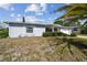 Single story house with white shutters and palm tree at 7511 Tyson Dr, Port Richey, FL 34668