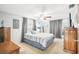 Spacious bedroom with ceiling fan, large bed, and ample closet space at 7511 Tyson Dr, Port Richey, FL 34668