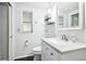 Bright bathroom with white vanity, granite countertop, and updated fixtures at 7511 Tyson Dr, Port Richey, FL 34668
