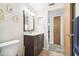 Guest bathroom with dark wood vanity and a toilet at 7511 Tyson Dr, Port Richey, FL 34668