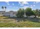 Ranch-style home with a large front yard and mature landscaping at 7511 Tyson Dr, Port Richey, FL 34668