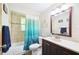 Clean bathroom featuring a shower/tub combo and a vanity with storage at 7511 Tyson Dr, Port Richey, FL 34668
