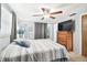 Bright bedroom with a comfortable bed, dresser, and large TV at 7511 Tyson Dr, Port Richey, FL 34668