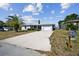 Single-story house with a driveway and palm tree at 7511 Tyson Dr, Port Richey, FL 34668