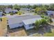 Aerial view of a single-story house with a large backyard and surrounding neighborhood at 7511 Tyson Dr, Port Richey, FL 34668