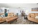 Open concept living room and dining area with wood floors at 7511 Tyson Dr, Port Richey, FL 34668
