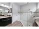Bathroom with a walk-in shower, double vanity, and dark brown cabinets at 8520 Grand Alberato Rd, Tampa, FL 33647