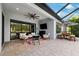 Relaxing covered patio with seating area, adjacent to pool at 8520 Grand Alberato Rd, Tampa, FL 33647