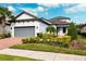 House exterior with gray garage door and well-maintained landscaping at 8520 Grand Alberato Rd, Tampa, FL 33647