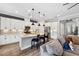 Open kitchen boasts white cabinets, granite countertops and breakfast bar at 8520 Grand Alberato Rd, Tampa, FL 33647
