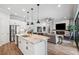 Open kitchen features a large island with granite countertops and stainless steel appliances at 8520 Grand Alberato Rd, Tampa, FL 33647