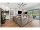 Spacious living room featuring a modern fireplace and large windows overlooking a pool at 8520 Grand Alberato Rd, Tampa, FL 33647