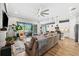 Open living room and kitchen with modern finishes and access to the backyard at 8520 Grand Alberato Rd, Tampa, FL 33647