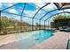 Enclosed pool and spa with a view of a lake at 8520 Grand Alberato Rd, Tampa, FL 33647