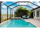 Enclosed pool and spa with lake view at 8520 Grand Alberato Rd, Tampa, FL 33647