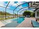Enclosed pool and spa with a lake view at 8520 Grand Alberato Rd, Tampa, FL 33647