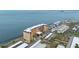 Aerial view of a waterfront building with parking and water access at 9 Haig Pl # 703, Dunedin, FL 34698