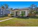 Renovated home with a white exterior, black accents, and palm trees at 1001 E New Orleans Ave, Tampa, FL 33603