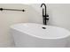 Bathroom featuring a freestanding bathtub with black fixtures at 1001 E New Orleans Ave, Tampa, FL 33603