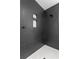 Modern shower with dark tile and hexagon floor at 1001 E New Orleans Ave, Tampa, FL 33603