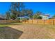Spacious backyard with a large oak tree and wooden fence at 1001 E New Orleans Ave, Tampa, FL 33603